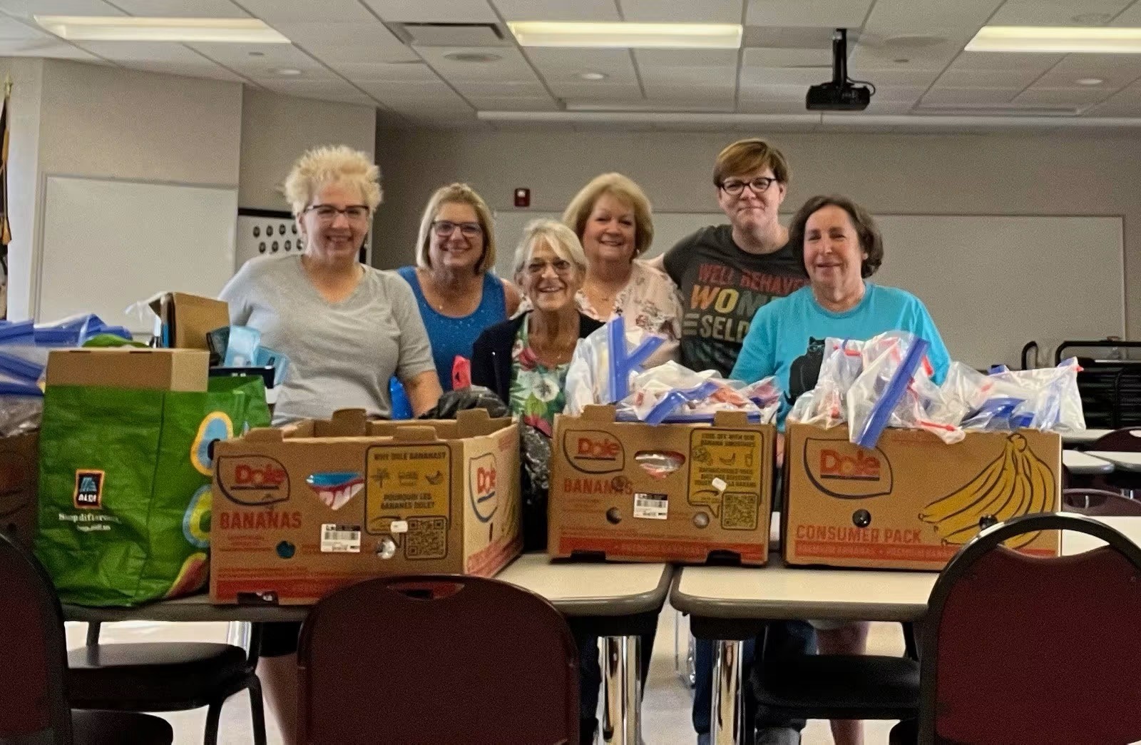 Madison Heights members proudly displaying the food stuffs gathered for the needy